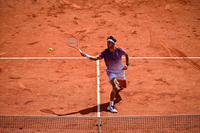 Italy's Flavio Cobolli plays a forehand volley to Germany's Alexander Zverev during their men's final singles match on day 15 of the French Open tennis tournament on Court Philippe-Chatrier at the Roland-Garros Complex in Paris on June 7, 2026. (Photo by JULIEN DE ROSA / AFP)