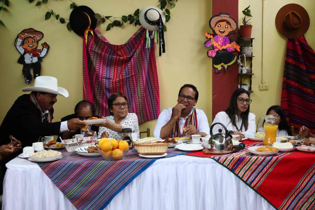 Peru's presidential candidate Roberto Sanchez (C), for the Juntos por el Peru party, attends an election-day breakfast with his wife Claudia Pinazzo (2nd R) and relatives in Huaral, Lima department, Peru on June 7, 2026. Peruvians will choose their ninth president in 10 years in a tight runoff election between conservative Keiko Fujimori and leftist Roberto Sanchez, who are trying to woo voters fed up with political chaos and rising crime. (Photo by Connie FRANCE / AFP)