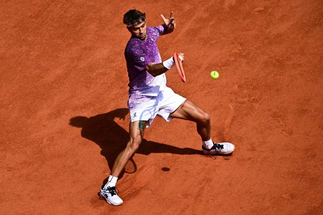Italy's Flavio Cobolli plays a forehand return to Germany's Alexander Zverev during their men's final singles match on day 15 of the French Open tennis tournament on Court Philippe-Chatrier at the Roland-Garros Complex in Paris on June 7, 2026. (Photo by JULIEN DE ROSA / AFP)