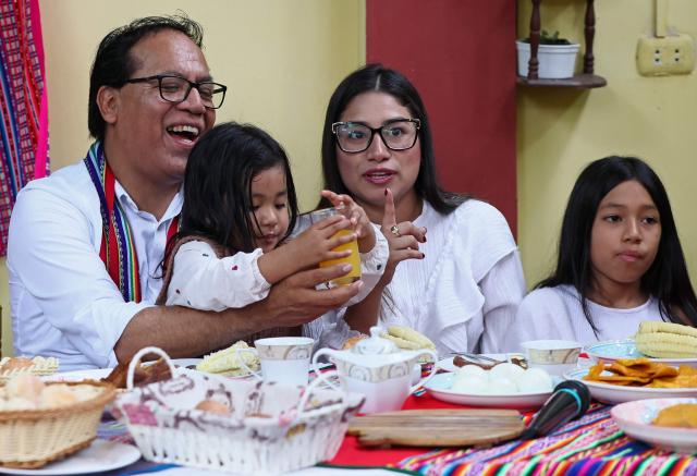 Peru's presidential candidate Roberto Sanchez, for the Juntos por el Peru party, attends an election-day breakfast with his wife Claudia Pinazzo (2nd R) and their daughters Qorianka (R) and Killa in Huaral, Lima department, Peru on June 7, 2026. Peruvians will choose their ninth president in 10 years in a tight runoff election between conservative Keiko Fujimori and leftist Roberto Sanchez, who are trying to woo voters fed up with political chaos and rising crime. (Photo by Connie FRANCE / AFP)