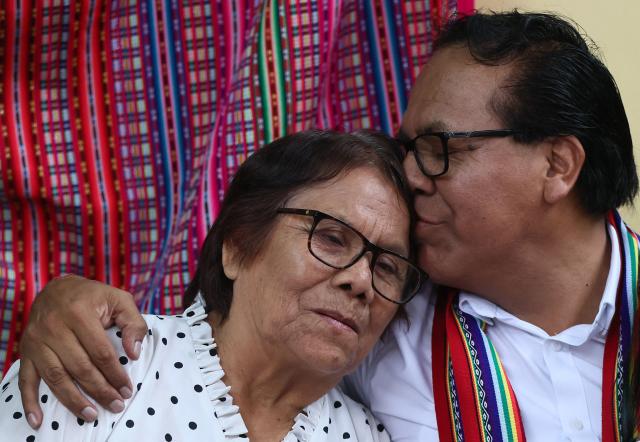 Peru's presidential candidate Roberto Sanchez, for the Juntos por el Peru party, kisses his mother during an election-day breakfast in Huaral, Lima department, Peru on June 7, 2026. Peruvians will choose their ninth president in 10 years in a tight runoff election between conservative Keiko Fujimori and leftist Roberto Sanchez, who are trying to woo voters fed up with political chaos and rising crime. (Photo by Connie FRANCE / AFP)