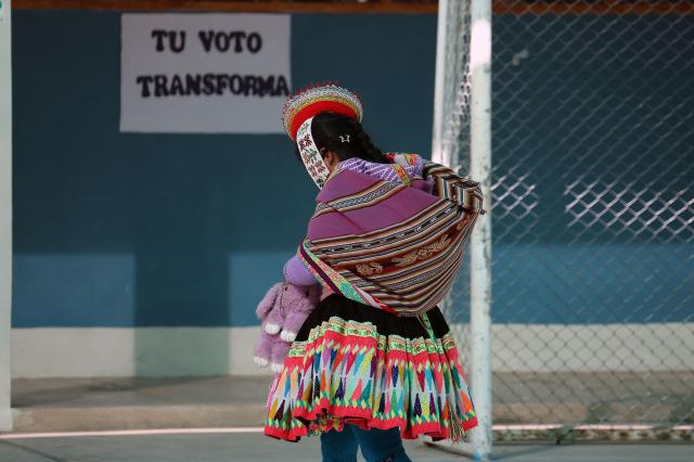 A local resident arrives at a polling station to cast her vote during the presidential election runoff in Ollantaytambo, department of Cusco, Peru, on June 7, 2026. Peruvians will choose their ninth president in 10 years in a tight runoff election between conservative Keiko Fujimori and leftist Roberto Sanchez, who are trying to woo voters fed up with political chaos and rising crime. (Photo by Jose Angulo / AFP)