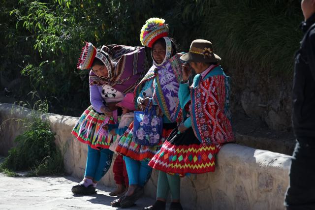 Locals sit outside a polling station during the presidential election runoff in Ollantaytambo, Cusco department, Peru, on June 7, 2026. Peruvians will choose their ninth president in 10 years in a tight runoff election between conservative Keiko Fujimori and leftist Roberto Sanchez, who are trying to woo voters fed up with political chaos and rising crime. (Photo by Jose Angulo / AFP)