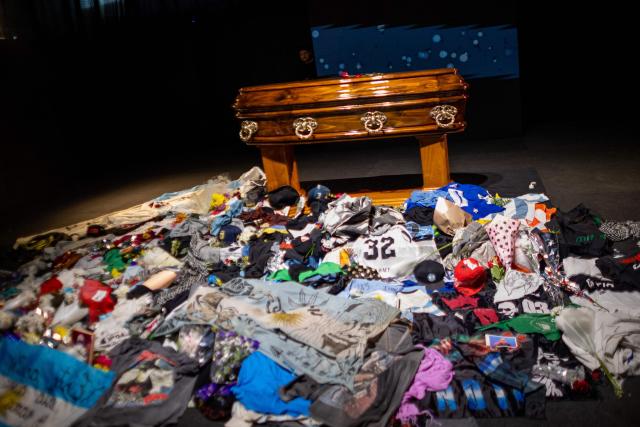 The coffin with the remains of Carlos Alberto "Indio" Solari, the iconic Argentine rock musician and former lead singer of Patricio Rey y sus Redonditos de Ricota, is pictured as fans queue to pay their respects at Villa Dominico, Buenos Aires Province, Argentina, on June 7, 2026. The singer died in Parque Leloir, Buenos Aires Province, on June 5 at the age of 77. (Photo by TOMAS CUESTA / AFP)