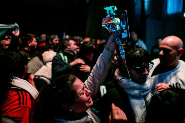 A fan pays her respects to the coffin with the remains of Carlos Alberto "Indio" Solari, the iconic Argentine rock musician and former lead singer of Patricio Rey y sus Redonditos de Ricota, at Villa Dominico, Buenos Aires Province, Argentina, on June 7, 2026. The singer died in Parque Leloir, Buenos Aires Province, on June 5 at the age of 77. (Photo by TOMAS CUESTA / AFP)
