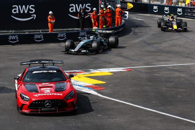 Mercedes' Italian driver Kimi Antonelli (C) and Red Bull Racing's French driver Isaac Hadjar (R) follow the safety car during Monaco Formula 1 Grand Prix at the Monaco street circuit in Monaco, ahead of the, on June 7, 2026. (Photo by Yves Herman / POOL / AFP)