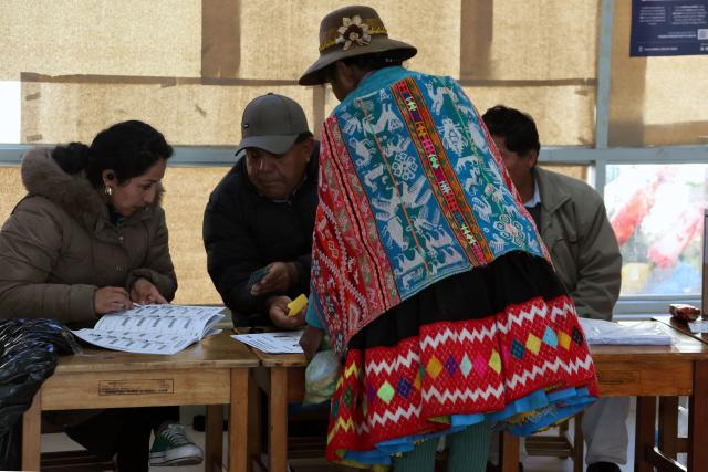 A local resident casts her vote during the presidential election runoff at a polling station in Ollantaytambo, department of Cusco, Peru, on June 7, 2026. Peruvians will choose their ninth president in 10 years in a tight runoff election between conservative Keiko Fujimori and leftist Roberto Sanchez, who are trying to woo voters fed up with political chaos and rising crime. (Photo by Jose Angulo / AFP)