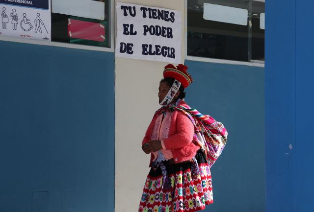 A local resident arrives at a polling station to cast her vote during the presidential election runoff in Ollantaytambo, department of Cusco, Peru, on June 7, 2026. Peruvians will choose their ninth president in 10 years in a tight runoff election between conservative Keiko Fujimori and leftist Roberto Sanchez, who are trying to woo voters fed up with political chaos and rising crime. (Photo by Jose Angulo / AFP)