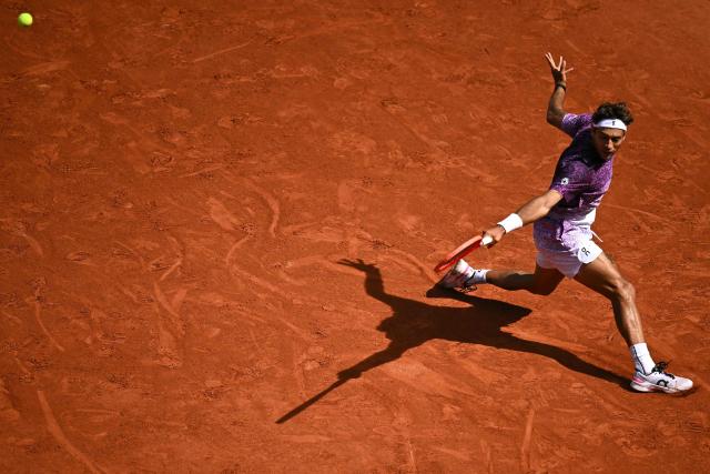 Italy's Flavio Cobolli plays a backhand return to Germany's Alexander Zverev during their men's final singles match on day 15 of the French Open tennis tournament on Court Philippe-Chatrier at the Roland-Garros Complex in Paris on June 7, 2026. (Photo by JULIEN DE ROSA / AFP)