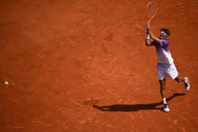 Italy's Flavio Cobolli plays a backhand return to Germany's Alexander Zverev during their men's final singles match on day 15 of the French Open tennis tournament on Court Philippe-Chatrier at the Roland-Garros Complex in Paris on June 7, 2026. (Photo by JULIEN DE ROSA / AFP)