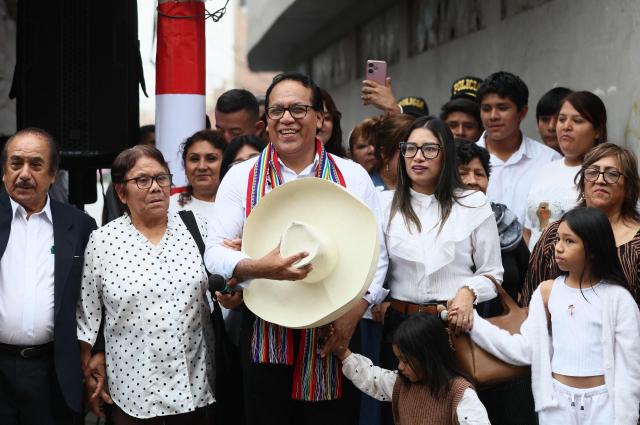 Peru's presidential candidate Roberto Sanchez, for the Juntos por el Peru party, gestures next to his wife Claudia Pinazzo, their daughters Killa and Qorianka, and his parents after an election-day breakfast in Huaral, Lima department, Peru on June 7, 2026. Peruvians will choose their ninth president in 10 years in a tight runoff election between conservative Keiko Fujimori and leftist Roberto Sanchez, who are trying to woo voters fed up with political chaos and rising crime. (Photo by Connie FRANCE / AFP)