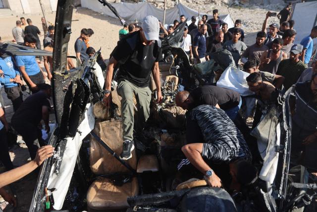 Palestinians inspect the wreckage of a car hit by an Israeli airstrike in Gaza City on June 7, 2026. Israel and Hamas continue to trade accusations of near-daily ceasefire violations, keeping the Gaza Strip locked in bloodshed months after a truce took effect in October. (Photo by Omar AL-QATTAA / AFP)