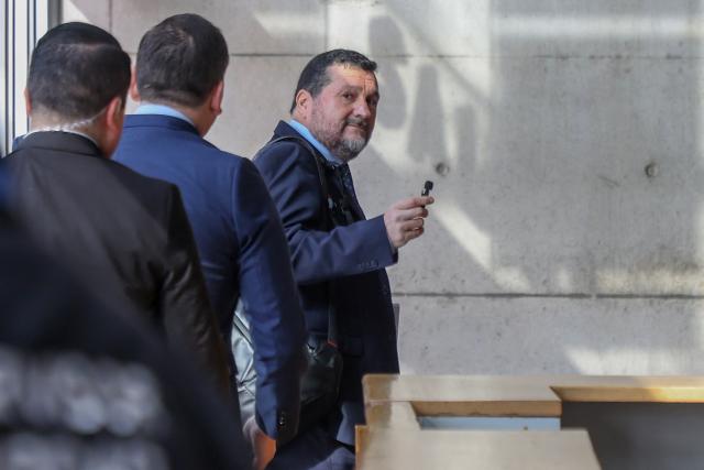 Regional prosecutor Hector Barros gestures as he arrives at the courthouse for the arraignment of 17 defendants in the Tren de Aragua organized crime case, charged with money laundering, illicit association, extortion, and smuggling, in Santiago on June 7, 2026. (Photo by Raul BRAVO / AFP)