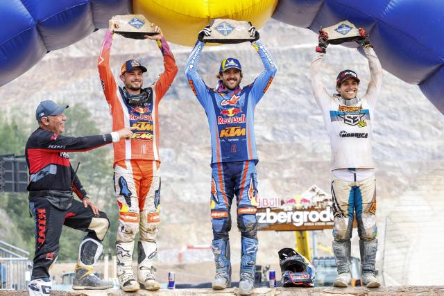 (LtoR) Event organiser Karl Katoch, second placed Canada's Trystan Hart, winner Germany's Manuel Lettenbichler and third placed Spain's Mario Roman celebrate on the podium after the Red Bull Hare Scramble motorbike competition event as part of the Erzbergrodeo on the Erzberg in Eisenerz, Austria on June 7, 2026. (Photo by ERWIN SCHERIAU / APA / AFP) / Austria OUT