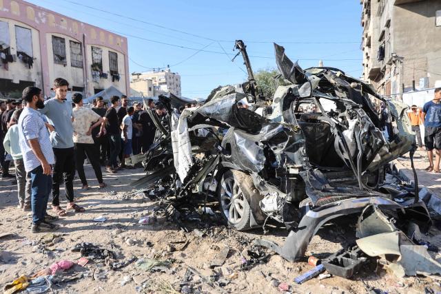 Palestinians look at the wreckage of a car hit by an Israeli airstrike in Gaza City on June 7, 2026. Israel and Hamas continue to trade accusations of near-daily ceasefire violations, keeping the Gaza Strip locked in bloodshed months after a truce took effect in October. (Photo by Omar AL-QATTAA / AFP)