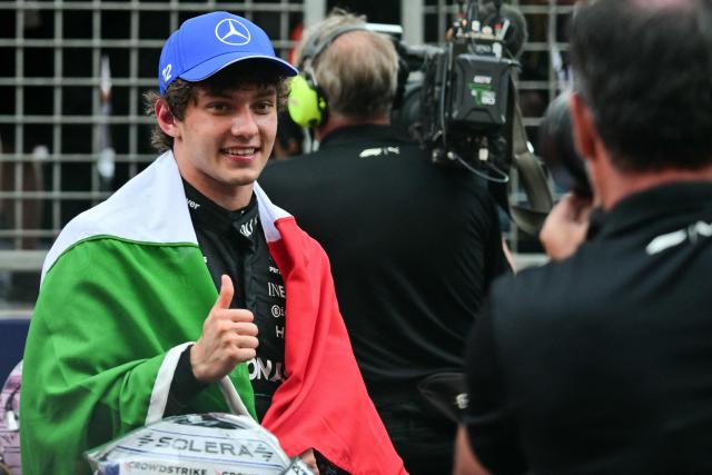 Winner Mercedes' Italian driver Kimi Antonelli wrapped in the national Italian flag celebrates after competing in the Monaco Formula 1 Grand Prix at the Monaco street circuit in Monaco, ahead of the, on June 7, 2026. (Photo by Andrej ISAKOVIC / AFP)
