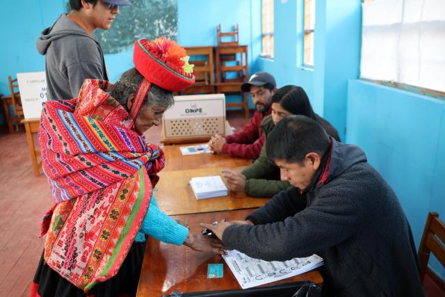 A local resident places her fingerprint in a voting registry during the presidential election runoff at a polling station in Ollantaytambo, Cusco department, Peru, on June 7, 2026. Peruvians will choose their ninth president in 10 years in a tight runoff election between conservative Keiko Fujimori and leftist Roberto Sanchez, who are trying to woo voters fed up with political chaos and rising crime. (Photo by Jose Angulo / AFP)