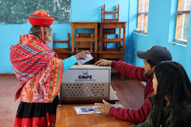 A local resident casts her vote during the presidential election runoff at a polling station in Ollantaytambo, department of Cusco, Peru, on June 7, 2026. Peruvians will choose their ninth president in 10 years in a tight runoff election between conservative Keiko Fujimori and leftist Roberto Sanchez, who are trying to woo voters fed up with political chaos and rising crime. (Photo by Jose Angulo / AFP)