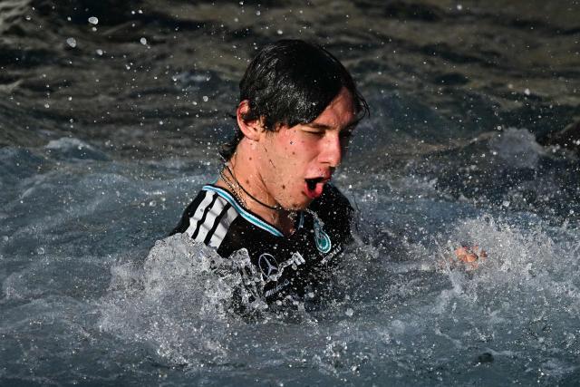 Winner Mercedes' Italian driver Kimi Antonelli celebrates in the sea after winning the Monaco Formula 1 Grand Prix at the Monaco street circuit in Monaco, ahead of the, on June 7, 2026. (Photo by Gabriel BOUYS / AFP)