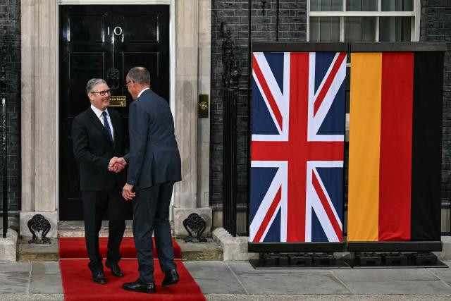 Germany's Chancellor Friedrich Merz (R) is welcomed by Britain's Prime Minister Keir Starmer (L) at 10 Downing Street ahead of a meeting that includes the leaders of Ukraine and France in central London on June 7, 2026. (Photo by Ben STANSALL / POOL / AFP)