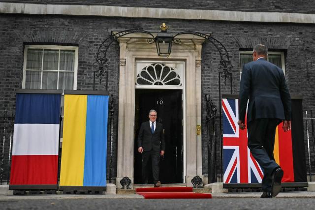 Germany's Chancellor Friedrich Merz (R) arrives as he is welcomed by Britain's Prime Minister Keir Starmer at 10 Downing Street ahead of a meeting that includes the leaders of Ukraine and France in central London on June 7, 2026. (Photo by Ben STANSALL / POOL / AFP)
