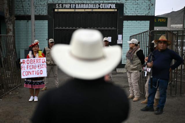 Supporters of former Peruvian president Pedro Castillo and presidential candidate Roberto Sanchez gather outside the Barbadillo prison, where Castillo is being held, in Lima on June 7, 2026, during the presidential runoff election. Peruvians will choose their ninth president in 10 years, in a tight runoff election between conservative Keiko Fujimori and leftist Roberto Sanchez who are trying to woo voters fed up with political chaos and rising crime. (Photo by ERNESTO BENAVIDES / AFP)