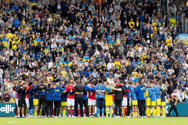 Denmark's and Ukraine's players huddle on the pitch during the football international friendly match between Denmark and Ukraine at Odense Stadium in Denmark, on June 7, 2026. Christian Eriksen collapsed during Denmark's friendly against Ukraine on June 7, 2026, five years after he suffered a cardiac arrest during the European Championships. (Photo by Bo Amstrup / AFP) / Denmark OUT