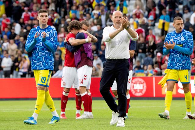 Denmark's head coach Brian Riemer (2nd R), Ukraine's midfielder #19 Danylo Ihnatenko and Ukraine's forward #04 Oleksandr Romanchuk (R) greet the fans as Denmark's forward #17 Kasper Hogh (2nd L) and Denmark's midfielder #14 Jens Stage hug after Denmark's midfielder #10 Christian Eriksen collapsed during the football international friendly match between Denmark and Ukraine at Odense Stadium in Denmark, on June 7, 2026. Christian Eriksen collapsed during Denmark's friendly against Ukraine on June 7, 2026, five years after he suffered a cardiac arrest during the European Championships. (Photo by Bo Amstrup / AFP) / Denmark OUT