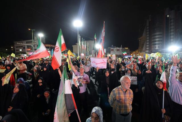 Pro-government Iranian demonstrators wave flags of Iran and Lebanon's Hezbollah movement after Isreali strikes on Beirut's southern suburbs in Tehran on June 7, 2026. Air raid sirens sounded in Israel on Sunday as its military worked to intercept barrages of incoming Iranian missiles for the first time since an April ceasefire took hold in the Middle East war. Iran's powerful Revolutionary Guards called the attack a "warning" after Israel struck Beirut's southern suburbs earlier in the day, threatening wider strikes in the event of repeated aggression. (Photo by ATTA KENARE / AFP) / 