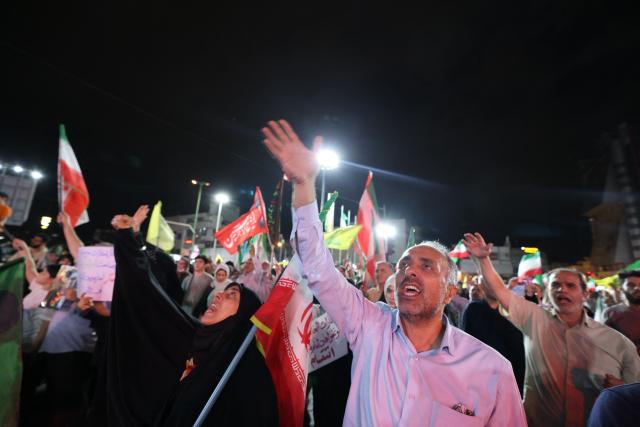 Pro-government Iranian demonstrators wave flags of Iran and Lebanon's Hezbollah movement after Isreali strikes on Beirut's southern suburbs in Tehran on June 7, 2026. Air raid sirens sounded in Israel on Sunday as its military worked to intercept barrages of incoming Iranian missiles for the first time since an April ceasefire took hold in the Middle East war. Iran's powerful Revolutionary Guards called the attack a "warning" after Israel struck Beirut's southern suburbs earlier in the day, threatening wider strikes in the event of repeated aggression. (Photo by ATTA KENARE / AFP) / 