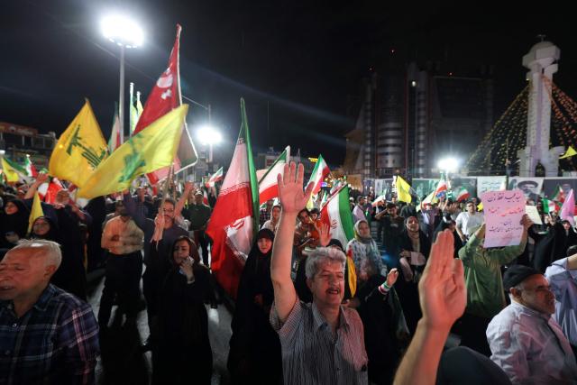 Pro-government Iranian demonstrators wave flags of Iran and Lebanon's Hezbollah movement after Isreali strikes on Beirut's southern suburbs in Tehran on June 7, 2026. Air raid sirens sounded in Israel on Sunday as its military worked to intercept barrages of incoming Iranian missiles for the first time since an April ceasefire took hold in the Middle East war. Iran's powerful Revolutionary Guards called the attack a "warning" after Israel struck Beirut's southern suburbs earlier in the day, threatening wider strikes in the event of repeated aggression. (Photo by ATTA KENARE / AFP) / 