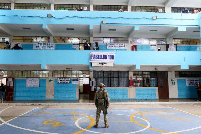 A Peruvian soldier stands guard during the presidential election runoff at Micaela Bastidas school in Lima on June 7, 2026. Peruvians will choose their ninth president in 10 years, in a tight runoff election between conservative Keiko Fujimori and leftist Roberto Sanchez who are trying to woo voters fed up with political chaos and rising crime. (Photo by Connie FRANCE / AFP)