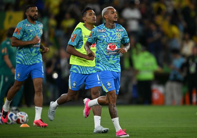(FILES) Brazil's defender #02 Wesley (R) warms up with teammates ahead of the international friendly football match between Brazil and Panama at the Maracana stadium in Rio de Janeiro, Brazil on May 31, 2026. The Brazilian Football Confederation (CBF) announced on June 7, 2026, that fullback Wesley, who suffered a muscle injury, will be replaced by midfielder Ederson on the roster for the 2026 World Cup, which kicks off on June 11. (Photo by Mauro PIMENTEL / AFP)
