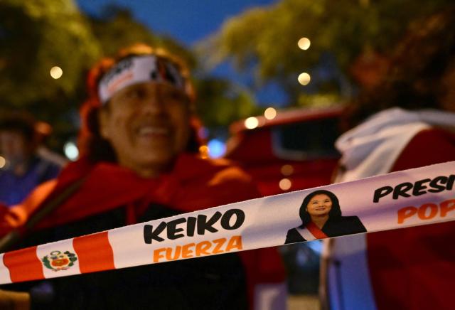 A supporter of Peru's presidential candidate Keiko Fujimori, for the Fuerza Popular party, shows a headband depicting her during the presidential election runoff in Lima on June 7, 2026. Peruvians will choose their ninth president in 10 years in a tight runoff election between conservative Keiko Fujimori and leftist Roberto Sanchez, who are trying to woo voters fed up with political chaos and rising crime. (Photo by MARTIN BERNETTI / AFP)