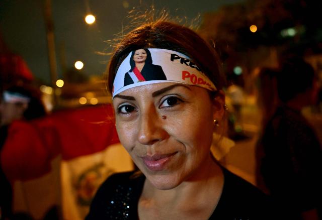 A supporter of Peru's presidential candidate Keiko Fujimori, for the Fuerza Popular party, wears a headband depicting her during the presidential election runoff in Lima on June 7, 2026. Peruvians will choose their ninth president in 10 years in a tight runoff election between conservative Keiko Fujimori and leftist Roberto Sanchez, who are trying to woo voters fed up with political chaos and rising crime. (Photo by MARTIN BERNETTI / AFP)