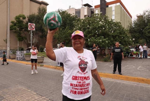 A woman holds a football during a protest called 'Wear the shirt for the disappeared' by the collective United Forces for the Disappeared of Nuevo Leon, FUNDENL, in Monterrey, Nuevo Leon, Mexico on June 6, 2026. (Photo by Julio Cesar AGUILAR / AFP)