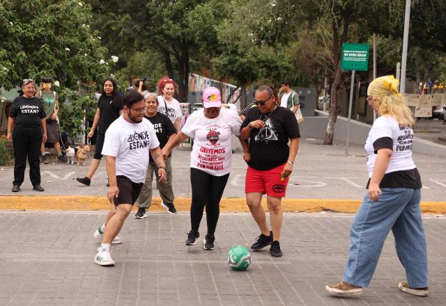 Relatives of missing persons from the collective United Forces for the Disappeared of Nuevo Leon, FUNDENL, play football during a protest called 'Wear the shirt for the disappeared' in Monterrey, Nuevo Leon, Mexico on June 6, 2026. (Photo by Julio Cesar AGUILAR / AFP)