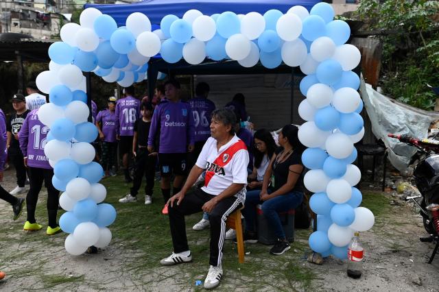 A man wearing a River Plate's jersey watches an amateur football match at the Maracana pitch in La Limonada neighbourhood in Guatemala City on June 7, 2026. Named after the iconic Maracana Stadium in Brazil, these dirt fields of the same name are a landmark of amateur football in Guatemala City. The Maracana pitch is located in an area that for years was marked by violence, bringing together players and fans from different neighborhoods of the capital every week. (Photo by Johan ORDONEZ / AFP)