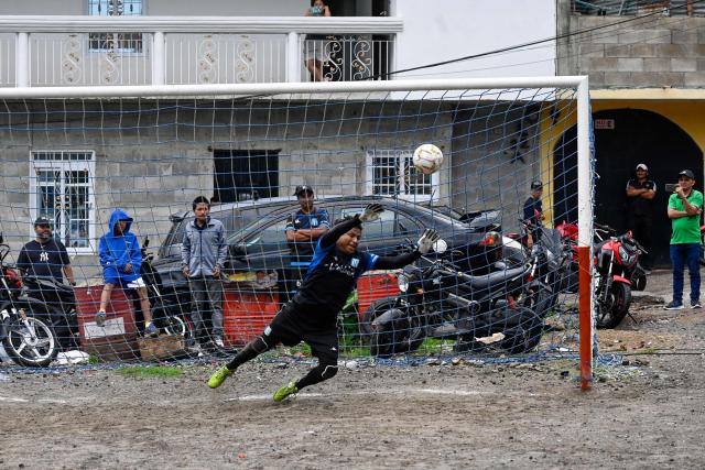 An amateur football player concedes a goal at the Maracana pitch in La Limonada neighbourhood in Guatemala City on June 7, 2026. Named after the iconic Maracana Stadium in Brazil, these dirt fields of the same name are a landmark of amateur football in Guatemala City. The Maracana pitch is located in an area that for years was marked by violence, bringing together players and fans from different neighborhoods of the capital every week. (Photo by Johan ORDONEZ / AFP)