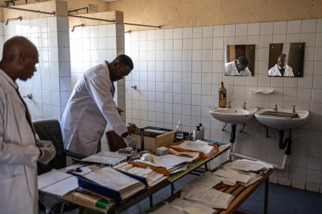 Microscopist Amrstrong Mgiba (L) waits for his colleague Nicholas Skhumbane (CL) to prepare blood smear slides before analysing them under a microscope at the Cunningmore Clinic in Bushbuckridge on May 26, 2026. Human-induced climate change, compounded by the La Nina weather pattern, has intensified extreme rainfall across southern Africa, the National Institute for Communicable Diseases (NICD) said, creating conditions that can fuel malaria transmission long after floodwaters recede.
In Mpumalanga, cases rose fourfold in January compared with a year earlier, jeopardising South Africa's goal of eliminating malaria by 2029. (Photo by EMMANUEL CROSET / AFP)