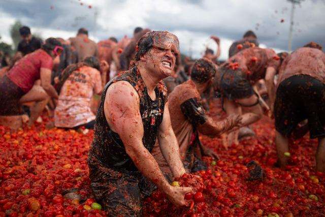 People throw tomatoes during the 16th Tomato Fight Festival known as "Tomatina" in Sutamarchan, Boyaca department, Colombia on June 7, 2026. (Photo by ESTEBAN VEGA LA-ROTTA / AFP)