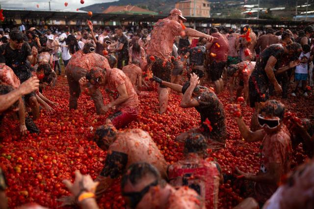 People throw tomatoes during the 16th Tomato Fight Festival known as "Tomatina" in Sutamarchan, Boyaca department, Colombia on June 7, 2026. (Photo by ESTEBAN VEGA LA-ROTTA / AFP)