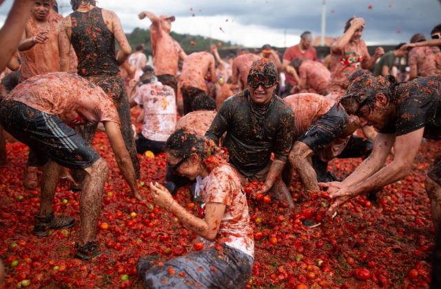 People throw tomatoes during the 16th Tomato Fight Festival known as "Tomatina" in Sutamarchan, Boyaca department, Colombia on June 7, 2026. (Photo by ESTEBAN VEGA LA-ROTTA / AFP)