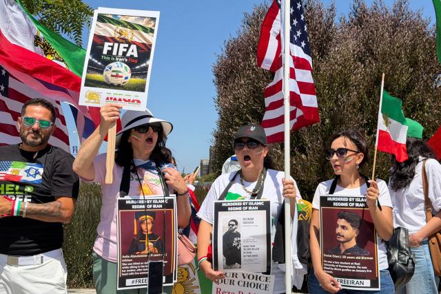 People wave US and pre-revolutionary Iranian flags as they protest the Iranian regime outside of Los Angeles Stadium (temporarly renamed from SoFi Stadium) in Inglewood, California, on June 7, 2026, ahead of the start of the 2026 FIFA World Cup. Iran are scheduled to open their Group G campaign against New Zealand in Los Angeles on June 15, before facing Belgium in the same city and then Egypt in Seattle. (Photo by Sarah LAI / AFP)