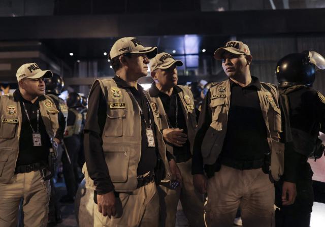 Peruvian police officers stand guard outside the house of presidential candidate Keiko Fujimori, for the Fuerza Popular party, following the first results of the presidential election runoff in Lima on June 7, 2026. Voting stations closed on June 7, 2026 in Peru's presidential election, with exit polls showing four-time candidate Keiko Fujimori with the slenderest of leads over her leftist rival Roberto Sanchez. (Photo by Anthony Nino de Guzman / AFP)