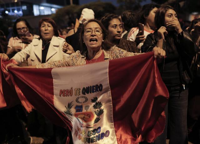 A supporter of Peru's presidential candidate Keiko Fujimori, for the Fuerza Popular party, shouts slogans outside her house following the first results of the presidential election runoff in Lima on June 7, 2026. Voting stations closed on June 7, 2026 in Peru's presidential election, with exit polls showing four-time candidate Keiko Fujimori with the slenderest of leads over her leftist rival Roberto Sanchez. (Photo by Anthony Nino de Guzman / AFP)