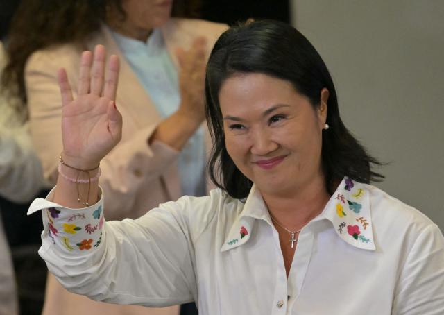 Peru's presidential candidate Keiko Fujimori, for the Fuerza Popular party, waves after a speech following the first results of the presidential election runoff in Lima on June 7, 2026. Voting stations closed on June 7, 2026 in Peru's presidential election, with exit polls showing four-time candidate Keiko Fujimori with the slenderest of leads over her leftist rival Roberto Sanchez. (Photo by MARTIN BERNETTI / AFP)