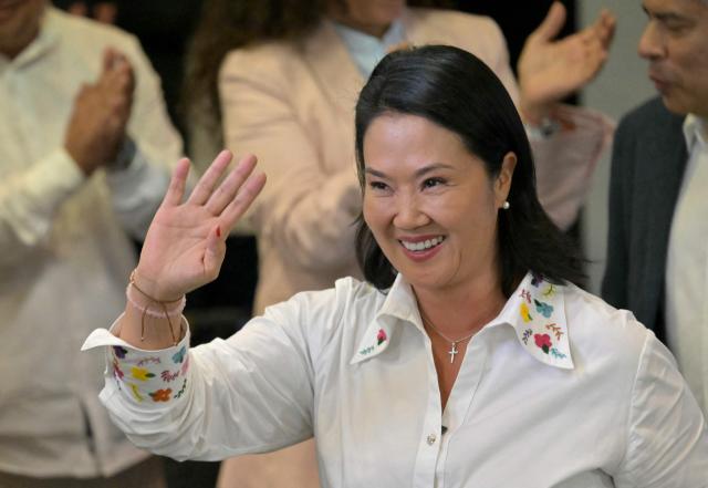 Peru's presidential candidate Keiko Fujimori, for the Fuerza Popular party, waves after a speech following the first results of the presidential election runoff in Lima on June 7, 2026. Voting stations closed on June 7, 2026 in Peru's presidential election, with exit polls showing four-time candidate Keiko Fujimori with the slenderest of leads over her leftist rival Roberto Sanchez. (Photo by MARTIN BERNETTI / AFP)