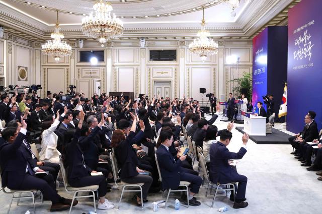 South Korean President Lee Jae Myung (R) attends a press conference to mark the first anniversary of his inauguration at the Blue House in Seoul on June 8, 2026. (Photo by Chung Sung-Jun / POOL / AFP)