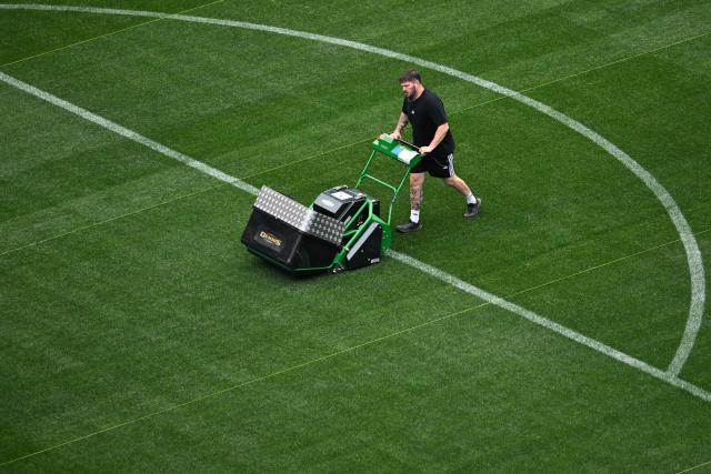A worker maintains the fully installed grass pitch at Los Angeles Stadium (temporarily renamed from SoFi Stadium) ahead of the 2026 FIFA World Cup in Los Angeles on June 7, 2026. (Photo by Patrick T. Fallon / AFP)